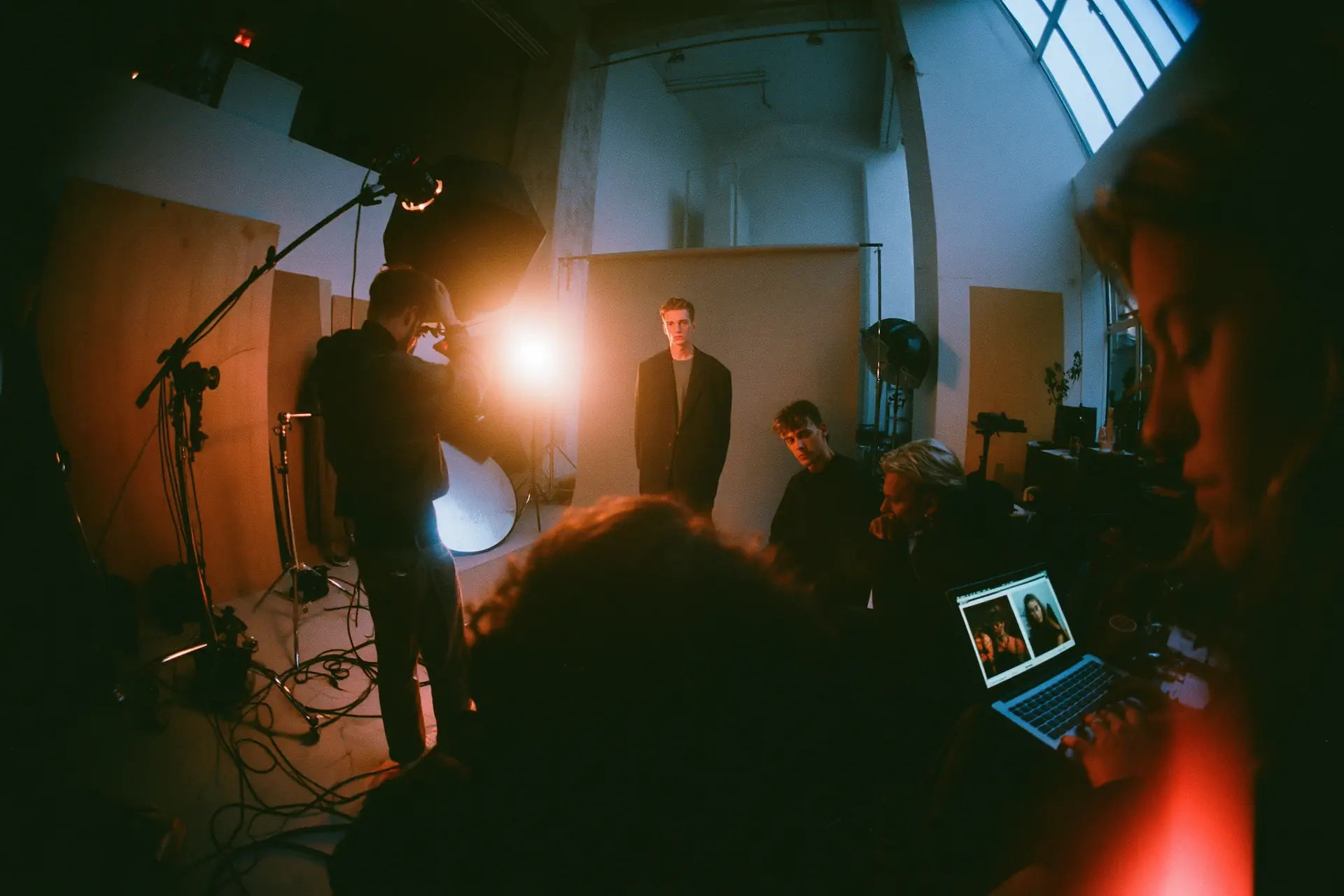 Fotostudio under en fotografering med ljussättning, modell och team